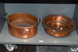 A late 19th to early 20th-century copper and brass basin, having twin handles; sold with a
