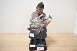 A moulded and painted ceramic figural 'Grandma's Darling' tobaccoo jar, formed as an elderly
