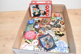 A selection of various badges, key rings, various including material, metal pin badges
