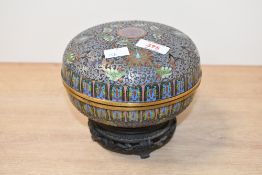 A 20th-century Chinese cloisonné lidded box, featuring intricate scrolled floral and foliate