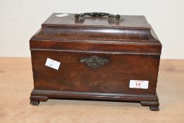 A late 19th to early 20th-century mahogany tea caddy, having an ornate brass escutcheon with three