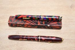 Two Conway Stewart Dinkie fountain pens. A Dinkie No 526 multi coloured and boxed lever fill and a