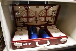A vintage Brexton picnic set, featuring a red vinyl faux basket weave case, to include plastic