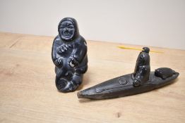 A late 20th-century Canadian Thorn Arts soapstone Inuit hunter in a Kayak; sold with a larger seated