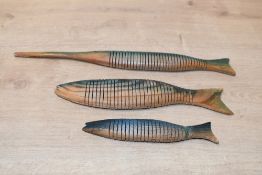 Three vintage articulated wooden fish sculptures, featuring three variations all handcarved and