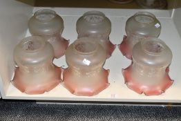 A group of six cranberry tinted, frosted and etched glass lamp/light shades, of traditional design