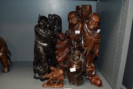 A quantity of late 19th to 20th-century Chinese and Japanese hardwood sculptures, to feature a
