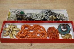 An assortment of costume jewellery, including coral pieces, paste set brooches and statement pieces