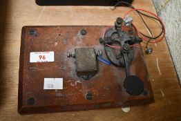 An early 20th-century telegraph practice set, featuring a morse key and buzzer mounted to a small