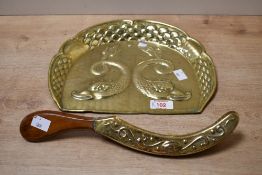 A late 19th-century Art Nouveau-style brass brush crumb tray, featuring an embossed design of two