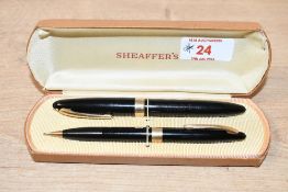 A boxed Sheaffer Touchdown fill fountain pen and pencil set in Black having Sheaffer 79 Lifetime