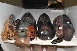 A carved African tribal mask, possibly Punu (Gabon) of elongated form with carved and stylised