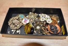 An assortment of brooches, including floral examples and paste set pieces