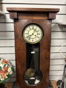 A late 19th-century Gustav Becker wooden Vienna regulator wall clock, featuring a large dark wood