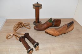 A pair of vintage shoe stretchers, a vintage wooden handled skipping rope and a wooden spool