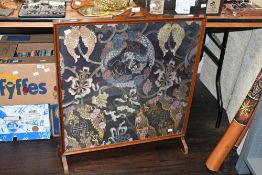A fine large early 20th-century Chinese-style embroidered fire screen, fitted behind glass within