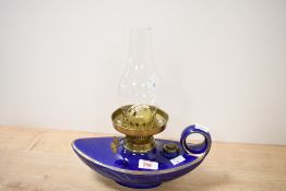 A decorative cobalt glazed ceramic, brass and glass Aladdin style oil lamp, of typical design with