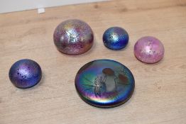 A John Ditchfield (Glasform) white metal mounted iridescent glass paperweight, of circular form with