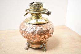 A Victorian Arts and Crafts brass and copper oil lamp, having a heavily hammered body of