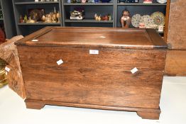 A stained mahogany box with hinged and panel top and plain body raised on bracket type feet, 35cm