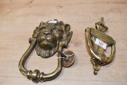 A decorative cast-brass lion mask door knocker 23cm sold along with another casts-brass door knocker