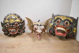 Three 20th-century Indonesian Balinese hand carved barong wood masks, to feature colourful hand