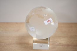 A vintage clear cut crystal glass globe paperweight, modelled as a terrestrial globe with etched