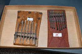 Two vintage African Mbiras, featuring hand carved wooden soundboards with metal keys, unmarked, (2),