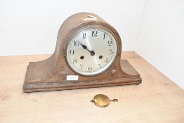 A 20th-century Art Deco-style wooden mantel clock, featuring a brushed metal dial of Arabic numerals