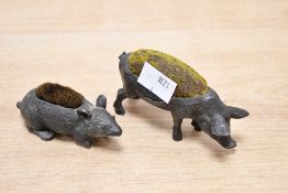 A late 19th to early 20th-century metal pig pin cushion, featuring a textured body and a soft