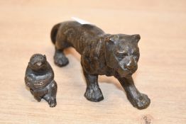 A late 19th to early 20th-century metal thought to be bronze tiger figure; sold with a small