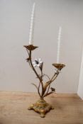 An early to mid 20th-century French-style gilded metal candelabra, having an ornate footed base