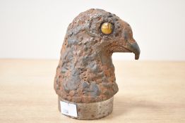 An unusual 20th-century cast iron falcon head statue, featuring a textured metal surface and two