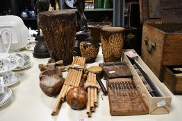 An interesting selection of ethnic musical instruments including two thumb pianos, pan pipes,