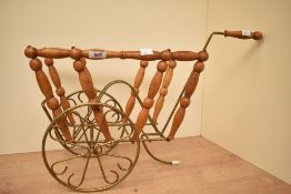 A vintage turned wood and brass magazine rack, of bike-shaped form, unmarked, 60cm in length,
