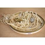 An assortment of faux pearl necklaces, of cream and white colour, some with paste set clasps