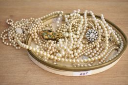 An assortment of faux pearl necklaces, of cream and white colour, some with paste set clasps