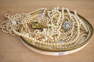 An assortment of faux pearl necklaces, of cream and white colour, some with paste set clasps