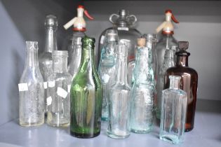 A selection of late 19th to 20th-century glass bottles, to feature a Boots The Chemist medicinal