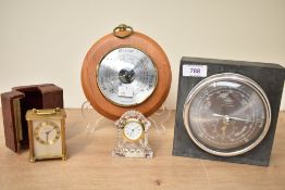 A collection of four barometers and clocks including a Looping brass carriage clock with a