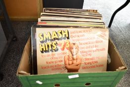 A collection of LP records including titles such as Smash Hits 73, John Denver, Jim Reeves, Perry