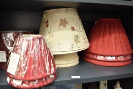 A selection of ten lamp shades including three red silk effect pleated table lamp shades and two