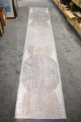 A hall runner in brown tones measuring 3m x 60cm.