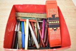 A box of various Fountain pens and pencils