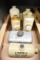 Five early to mid 20th-century stoneware bed warmers; sold with a metal example, some marked but not