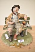 A Capodimonte figurine 'Good Hearted Tramp'. The Tramp figurine has suffered damage to his toe.