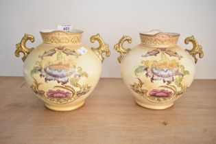 Two Victorian S. Fielding and Company pottery baluster vases with double gilded handles, renamed