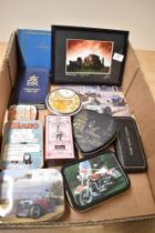 A small collection of vintage tins, an autograph album and a framed photograph of Stonehenge after
