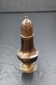 An Edwardian silver sugar caster, the pointed finial over the pierced tops on an octagonal body,