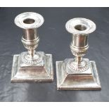 A pair of Victorian silver candlesticks, of traditional form having circular sconces with bead